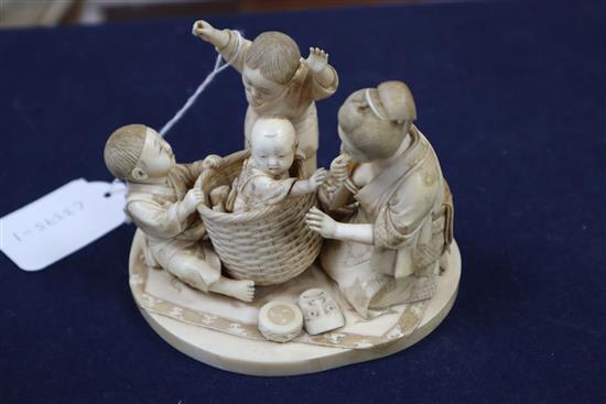 A good Japanese ivory okimono of a lady and children playing, Meiji period, H.9.5cm, W.12.2cm